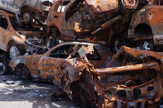 war in ukraine. Car graveyard. Shot cars of civilians. russia's war against Ukraine. Burnt and blown up car. Cars damaged after shelling. irpin bucha. war crimes.