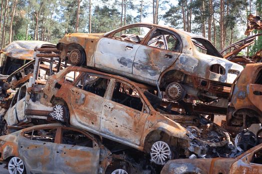 war in ukraine. Car graveyard. Shot cars of civilians. russia's war against Ukraine. Burnt and blown up car. Cars damaged after shelling. irpin bucha. war crimes.