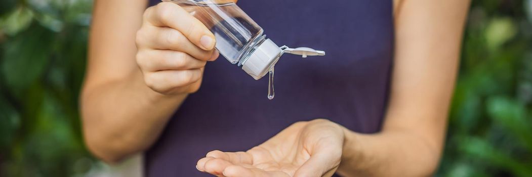 Women's hands using wash hand sanitizer gel. BANNER, LONG FORMAT