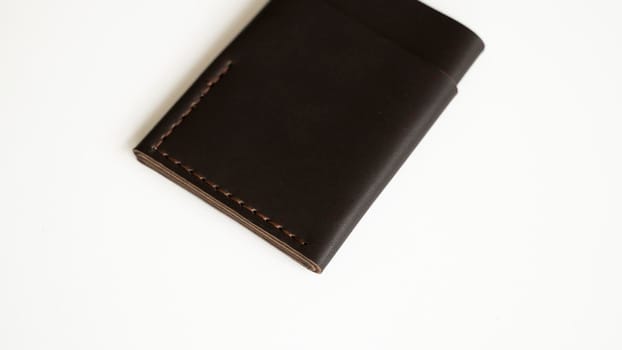 Brown empty men's business handmade leather card holder with isolated on white background. Selective focus, copy space, close up