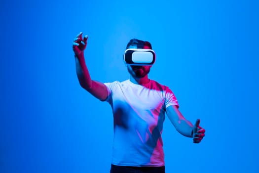 Architect in VR glasses working in augmented reality. Man wearing virtual reality glasses, sliding and zooming while interacting with a interface of virtual world