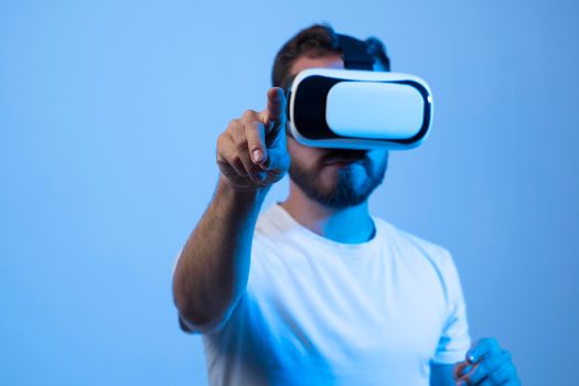 Young man developer working with a VR headset in a virtual world and create new products and applications