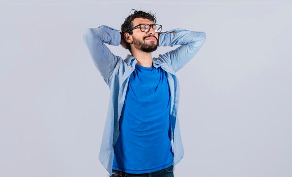 Relaxed smiling guy with hands behind his head, Relaxed man with closed eyes with hands behind his head, Satisfied man with hands behind his head, Concept of relaxed man with free time