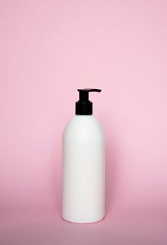 Liquid container for gel, lotion, cream, shampoo, bath foam on pink background. Cosmetic plastic bottle with white dispenser pump. Mock up template for design