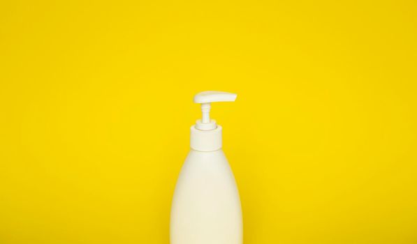 Liquid container for gel, lotion, cream, shampoo, bath foam on yellow background. Cosmetic plastic bottle with white dispenser pump. Mock up template for design