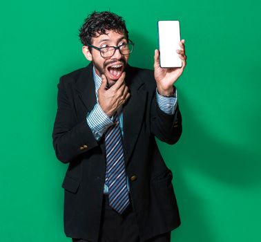 Businessman showing a cell phone from the front, happy businessman showing his cell phone isolated