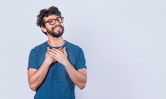 Attractive friendly and positive looking young man with a charming sincere smile feeling grateful