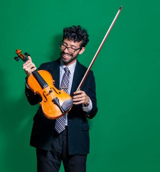 Happy violinist with her violin, violinist showing her violin on isolated background