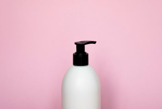 Liquid container for gel, lotion, cream, shampoo, bath foam on pink background. Cosmetic plastic bottle with white dispenser pump. Mock up template for design