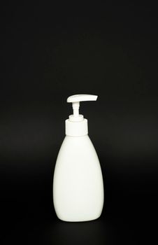 White plastic bottle used for shampoo or soap on black background.. Mock up template for design