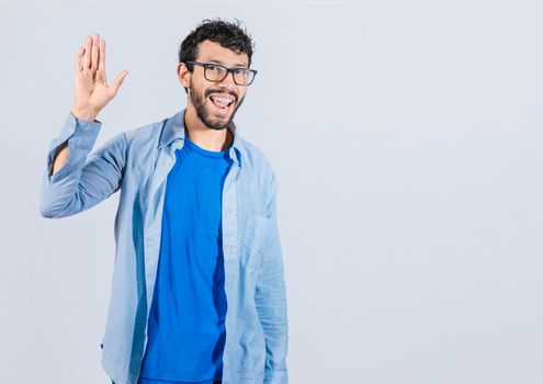 Man raising arm and waving friendly, isolated handsome man saying hi, friendly face man saying goodbye, concept of man saying hi on isolated background