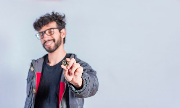 Man holding bitcoin coin, Close up of a guy holding bitcoin coin, concept of entrepreneurship and investment with bitcoin