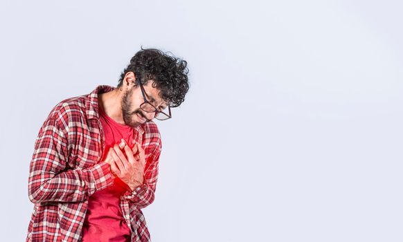Man with heart pain on isolated background, man with chest pain isolated, man with tachycardia, young man with chest pain isolated