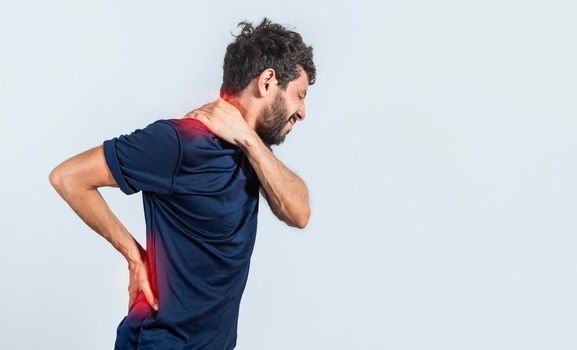 Man with spine and shoulder problems, person with back and shoulder problems on isolated background, lumbar and muscular problems concept