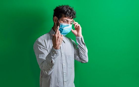 A guy wearing a double mask, young man wearing a double mask, young man taking action against covid19