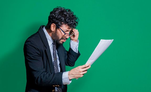 Confused businessman with documents in hand, puzzled businessman with documents in hand