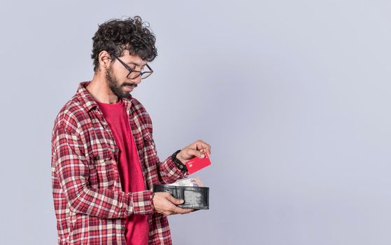 man taking out credit card from his wallet, a guy paying with credit card on isolated background , concept of man with credit card