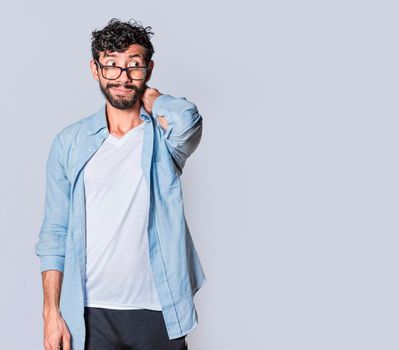 Latin young man with awkward face isolated on white background, Concept of an awkward guy