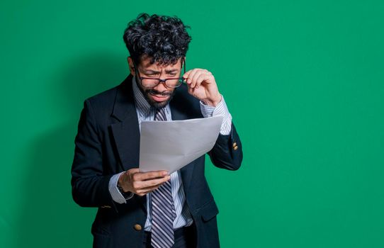 Confused businessman with documents in hand, puzzled businessman with documents in hand