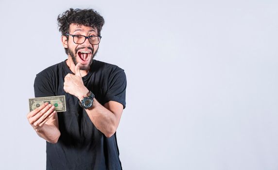 Happy man holding banknote in his hand, man with a banknote in his hand with thumb up, saving man concept, guy with money isolated