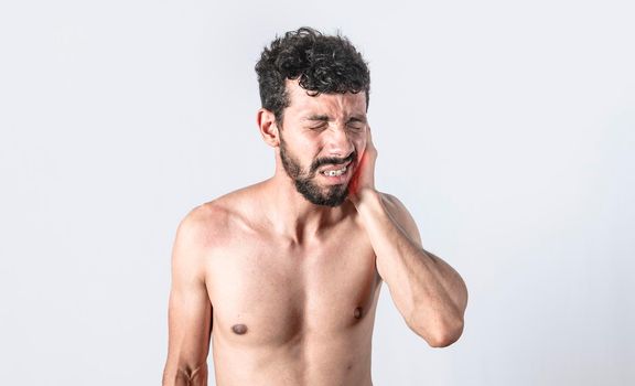 Person with earache on isolated background, man with earache on isolated background, ear disease concept