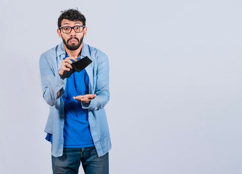 Sad man holding empty wallet and looking at the camera, Unhappy and surprised man looking into an empty wallet, Person seeing his empty wallet, Man with financial problems