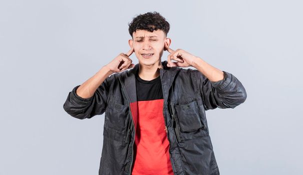 Man covering his ears isolated, guy covering his ears on isolated background, people with hands on his ears isolated, man ignoring problems covering his ears