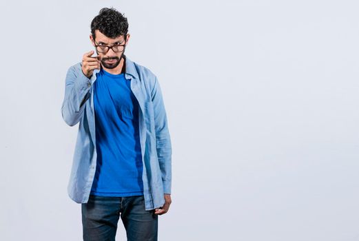 Hey you, be careful. bearded guy looking angry and warning, angry man threatening finger at camera, concept of angry person threatening head on