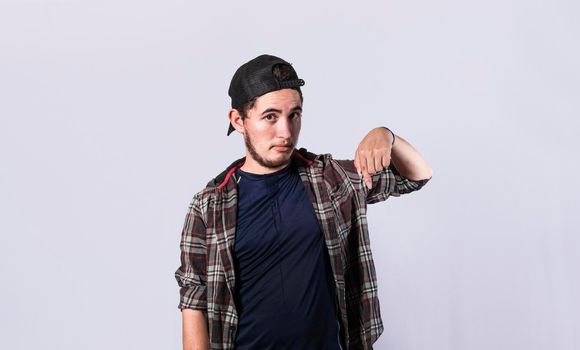 Friendly bearded man pointing down on isolated background, friendly guy pointing down and recommending