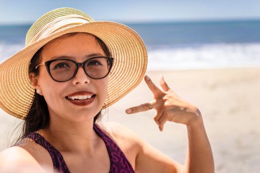 Pretty girl taking a selfie on the beach, happy pretty girl taking a selfie on the beach, vacation concept