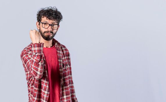 Man showing fist to camera, aggressive facial expression, serious man showing his fist to camera