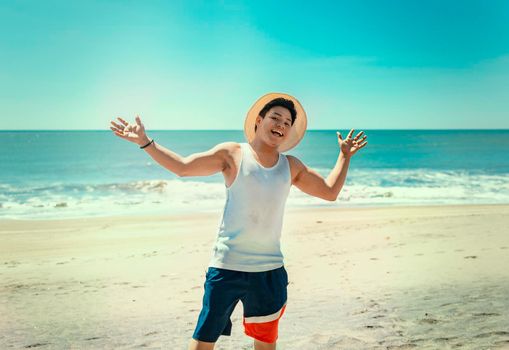 Happy handsome man on vacation outdoors, Happy latin young man on the beach, Tourist travel concept