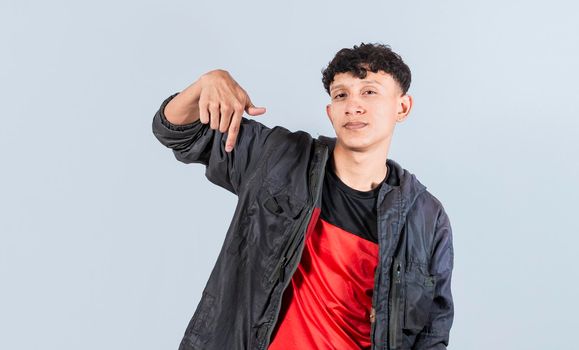 Friendly guy pointing down on isolated background, friendly guy pointing down and recommending