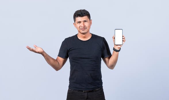 Handsome man smiling positive showing mobile phone blank screen with another hand palm open, excited happy male holding smartphone 