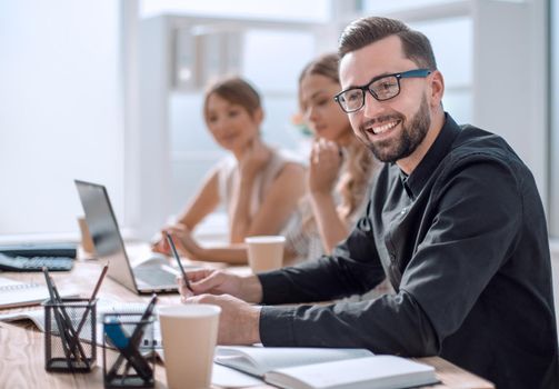 smiling businessman in the workplace in the office. photo with copy space