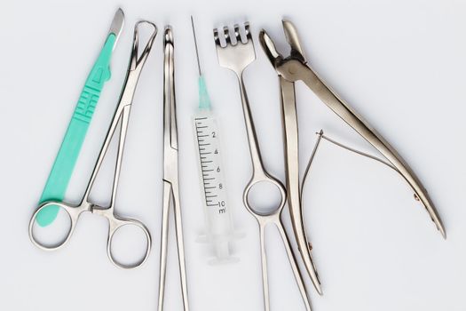 Top view of various surgical instruments - syringe, tongs etc.