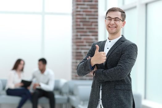 smiling businessman showing thumb up. concept of success