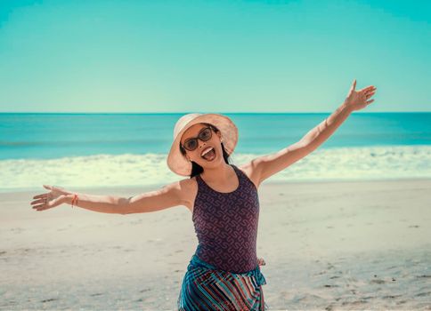 woman in hat happy on the beach, happy pretty young woman on vacation, vacation concept