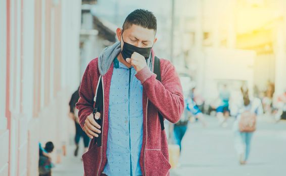 Coughing man with surgical mask, man with mask coughing in the street, concept of people with respiratory problems