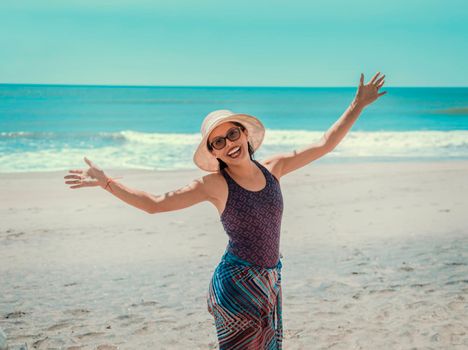 woman in hat happy on the beach, happy pretty young woman on vacation, vacation concept