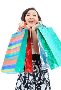 Happy young adult girl, with color-coded bags.