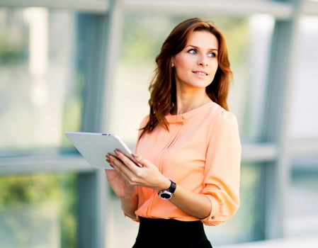 Young smiling business woman holding digital tablet computer