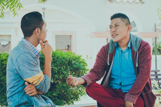 Two young people having a conversation outdoors, two friends having a conversation, concept of respect and friendly conversation