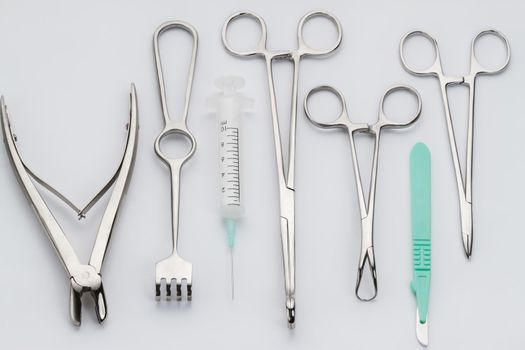 Overhead view of various surgical instruments - syringe, tongs etc.