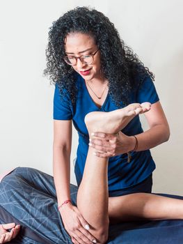 Knee flexion physiotherapy, rehabilitation concept, Physiotherapist with patient