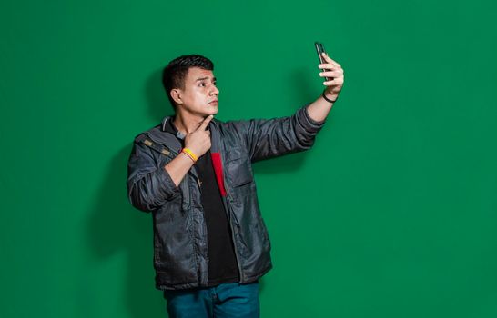 Guy taking photo isolated, man taking some selfie with isolated background