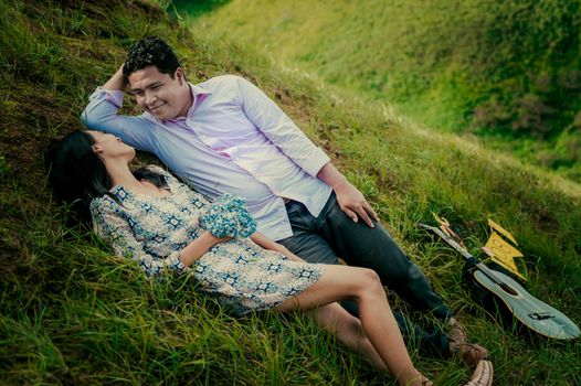 Wedding couple lying on the grass, couple lying on the grass, love concept