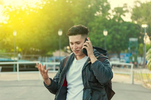 Man calling on the phone, young man calling on cell phone, latin guy calling on the phone