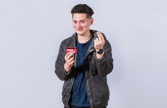 Handsome man holding credit card, A guy holding credit card smiling, electronic payment concept