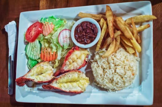 Plate of breaded shrimp with rice on the table with COPY SPACE, menu of breaded shrimp served on wooden table